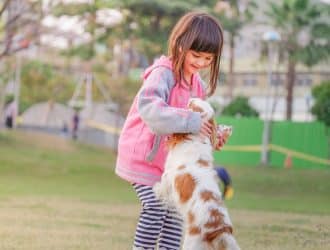 Illustration of a person sneezing with a dog nearby